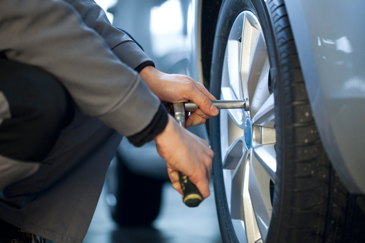 Auto mechanic changing a tire