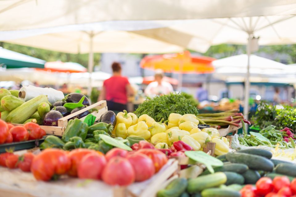 Farmers' food market stall with variety of organic vegetables.