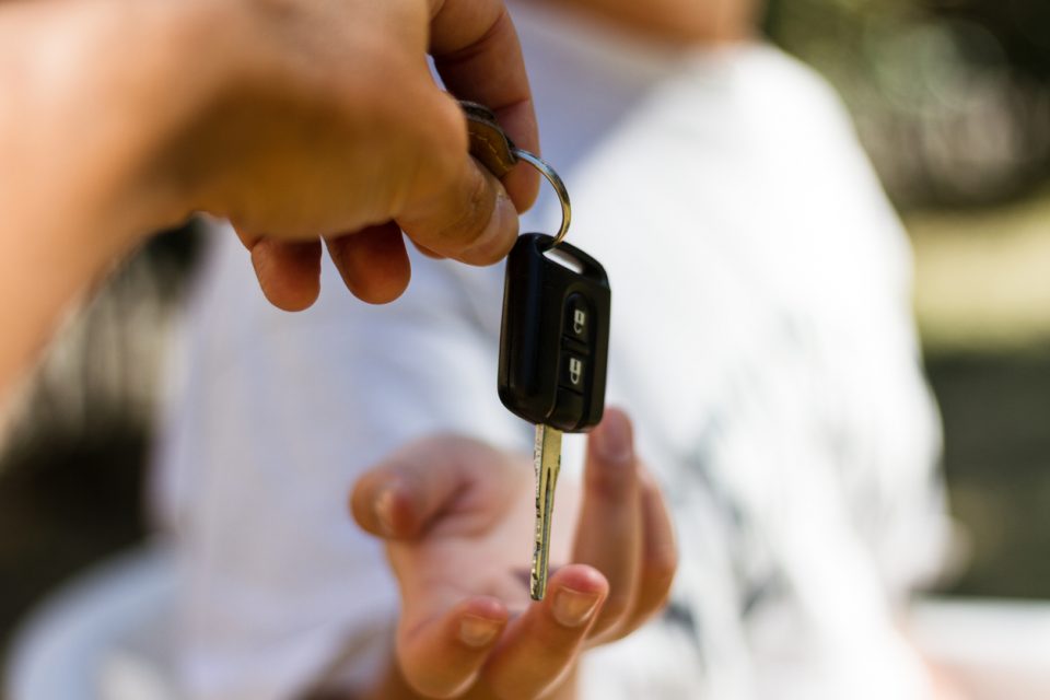 Girl receives the key of her used Honda