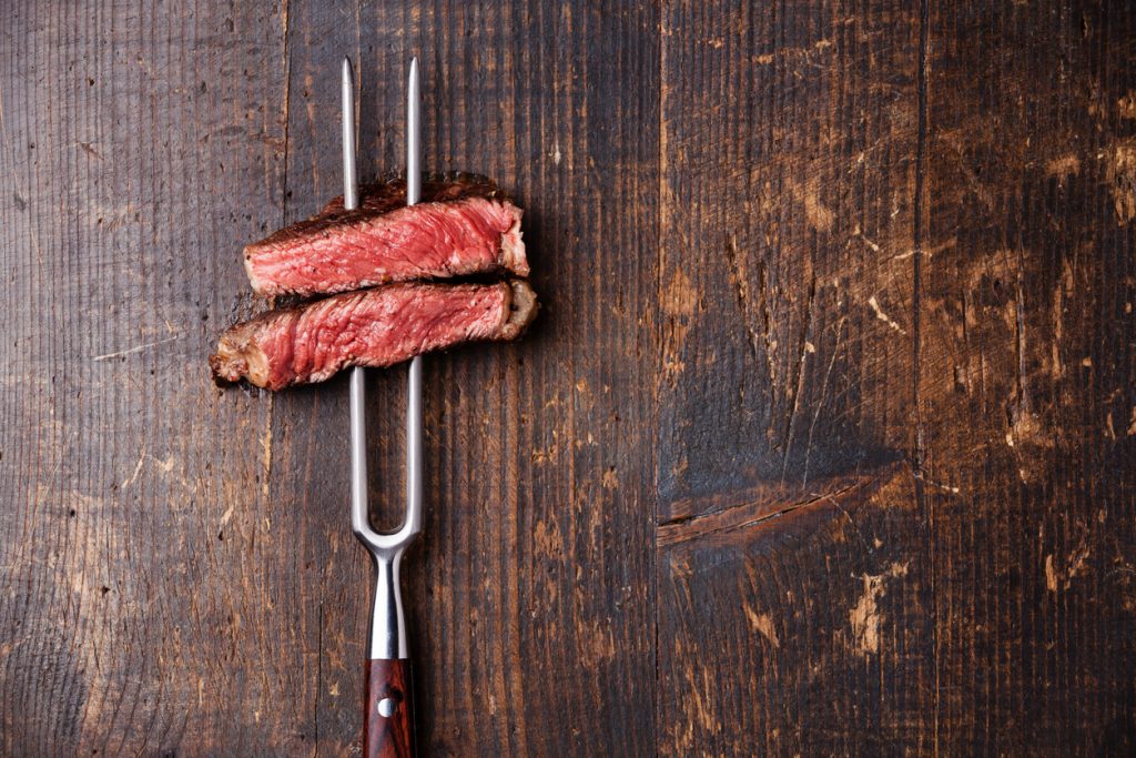 Slices of Steak Ribeye on meat fork