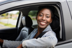 Portrait of young woman driving a car - Barbour Hendrick Honda