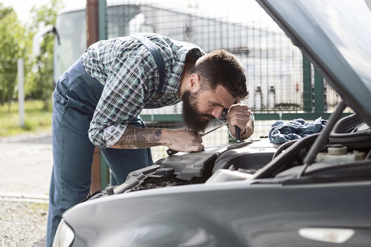 mechanics fixing a car